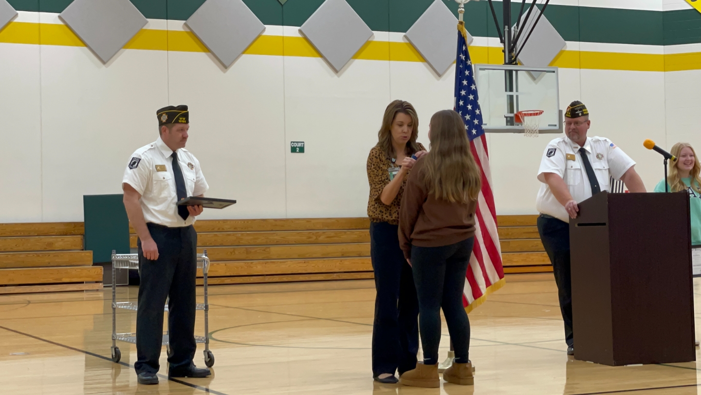 Leanne Greff pins winners and Post Adjutant Mike Desjarlais hands out checks and certificates
